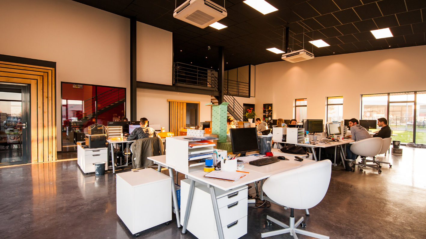 A group of people sitting at desks working on computers