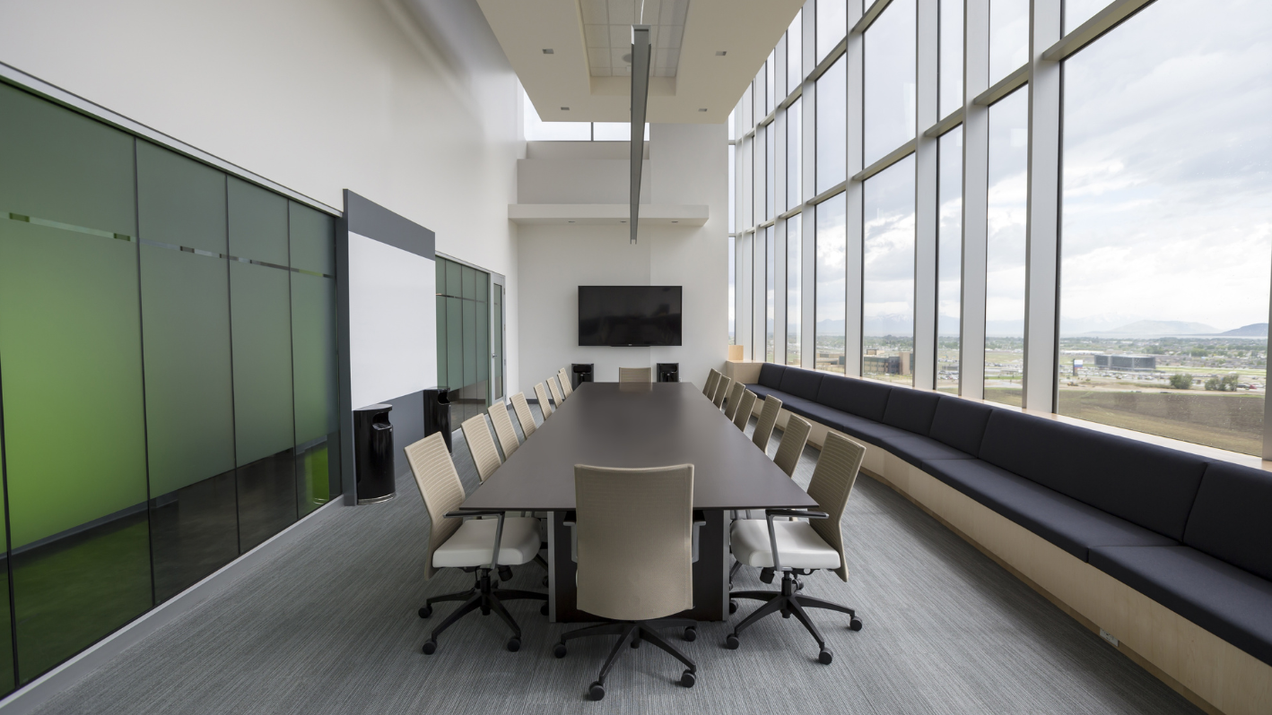 A conference room with a long table and chairs